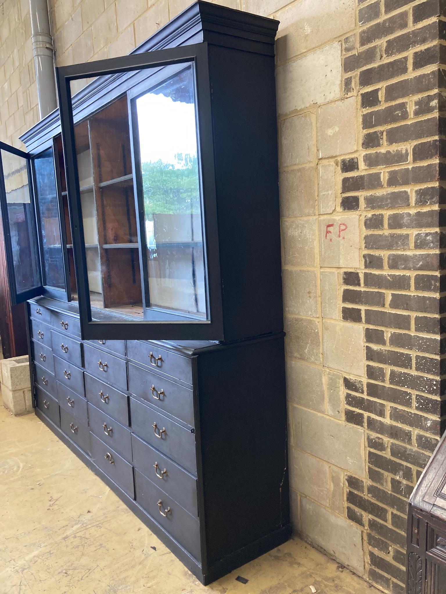 A Victorian painted pine glazed cabinet fitted twenty drawers, by repute The Bible Cabinet from Westminster Abbey, length 280cm, depth 54cm, height 244cm